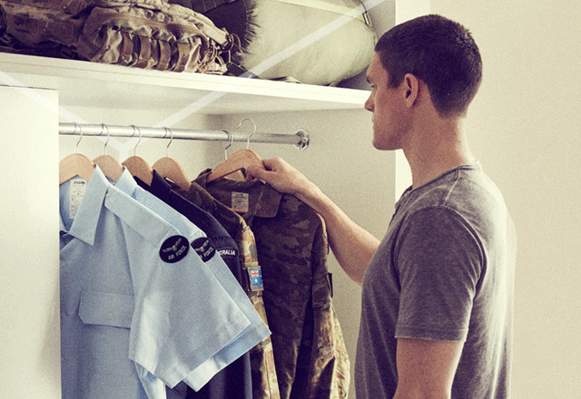Man choosing a shirt from a rack.