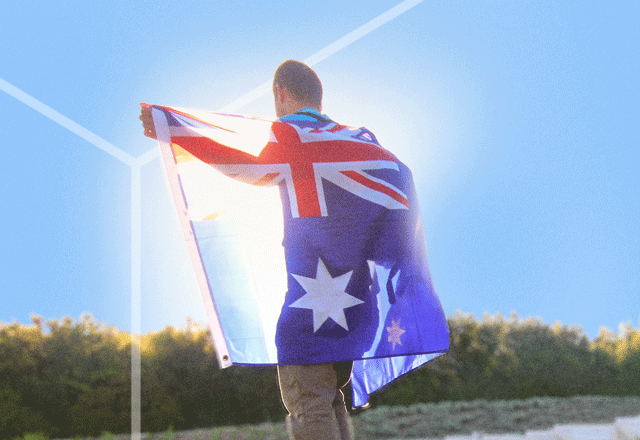 Man with Australian flag draped over shoulders.