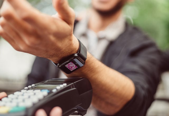 Man paying with smart watch.